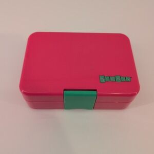 Yumbox Mini Snack bento lunch box in pink with a green latch